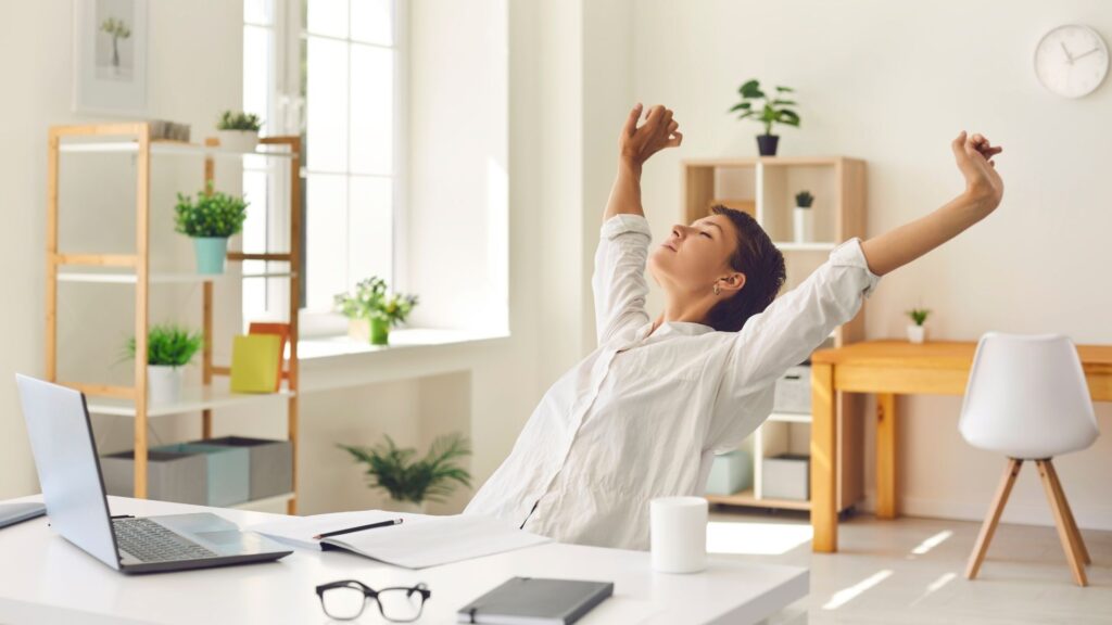 A person sits at a desk in a bright office