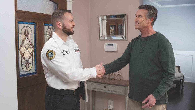 an hvac tech shaking hands with a customer