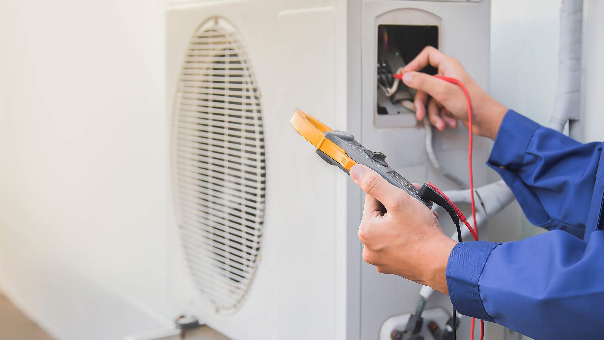 HVAC service technician using gauges to check refrigerant