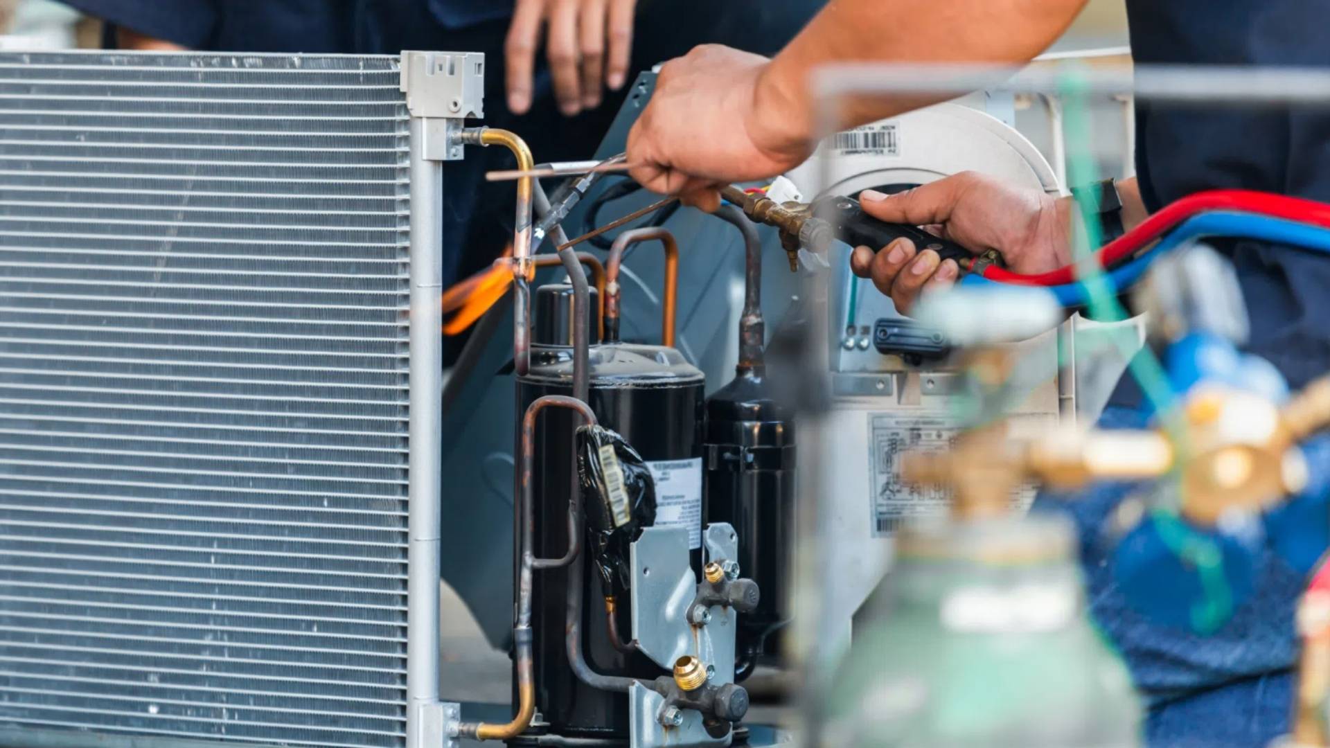 technician performing AC maintenance