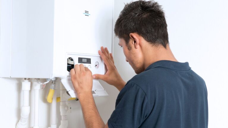 boiler maintenance in Michigan man in black shirt fixing boiler