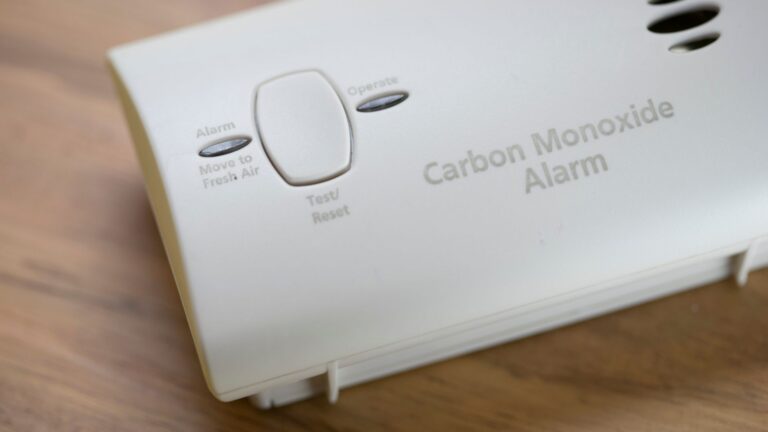 White carbon monoxide alarm with a test/reset button and indicator lights for Alarm, Operate, and Move to Fresh Air.