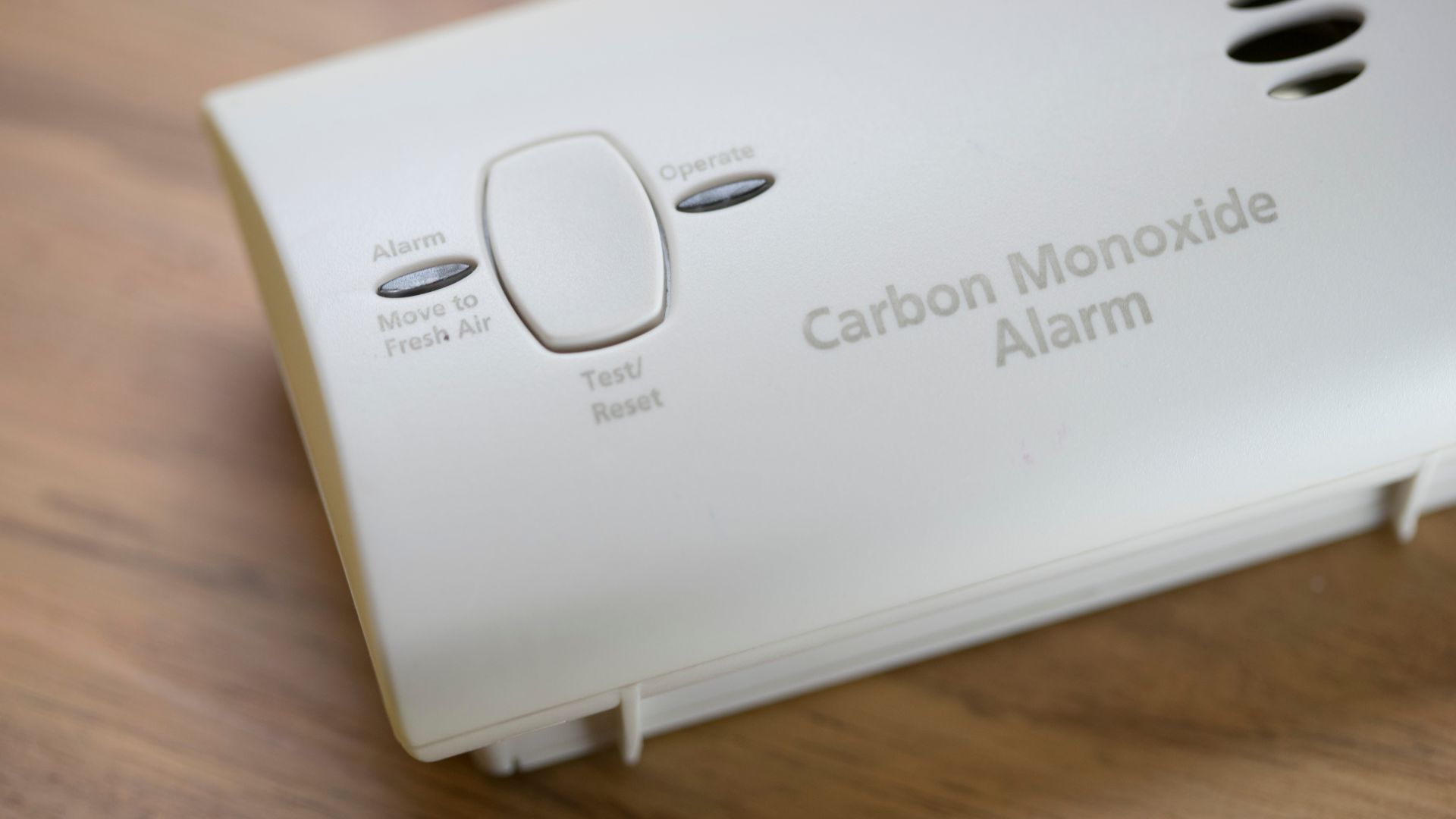 White carbon monoxide alarm with a test/reset button and indicator lights for Alarm, Operate, and Move to Fresh Air.